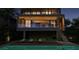Modern home at night with pool and deck at 1725 Gulf Rd, Tarpon Springs, FL 34689