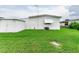 Back of manufactured home with shed and grassy area at 37308 Beverly Ave, Zephyrhills, FL 33542