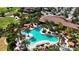 Aerial view of resort-style pool with lounge chairs and palm trees at 13506 Messina Loop # 105, Bradenton, FL 34211