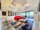Open living space with red sectional sofa, fireplace, and built-in shelving at 13506 Messina Loop # 105, Bradenton, FL 34211