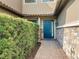 Private entry with blue door and stone wall at 13506 Messina Loop # 105, Bradenton, FL 34211