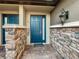 Modern building entrance with blue door and stone accents at 13506 Messina Loop # 105, Bradenton, FL 34211