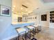 Kitchen features a breakfast bar with white stools and modern pendant lighting at 13506 Messina Loop # 105, Bradenton, FL 34211