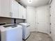 Laundry room with washer, dryer, and upper cabinets at 13506 Messina Loop # 105, Bradenton, FL 34211