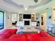 Spacious living area with a red couch, fireplace, and built-in shelving at 13506 Messina Loop # 105, Bradenton, FL 34211
