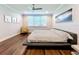 Bedroom with hardwood floors, a ceiling fan, and a view of another room at 13506 Messina Loop # 105, Bradenton, FL 34211
