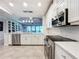 Spacious kitchen with island, white cabinets and stainless steel appliances at 13506 Messina Loop # 105, Bradenton, FL 34211
