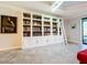 Spacious library with built-in shelving, ladder, and white cabinets at 13506 Messina Loop # 105, Bradenton, FL 34211
