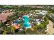 Aerial view of community pool with surrounding landscaping and cabanas at 13506 Messina Loop # 105, Bradenton, FL 34211