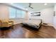 Bright bedroom featuring hardwood floors and large windows with plantation shutters at 13506 Messina Loop # 105, Bradenton, FL 34211