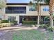 Rear exterior view of the property, showcasing landscaping and patio at 13506 Messina Loop # 105, Bradenton, FL 34211