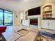 Living room boasts a fireplace, built-ins, and a red sectional sofa at 13506 Messina Loop # 105, Bradenton, FL 34211