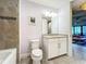 Clean bathroom with granite countertop, white cabinets and tiled shower at 13506 Messina Loop # 105, Bradenton, FL 34211