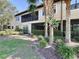 Landscaped backyard with building exterior and lush greenery at 13506 Messina Loop # 105, Bradenton, FL 34211