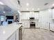 Modern kitchen with stainless steel appliances and white cabinetry at 13506 Messina Loop # 105, Bradenton, FL 34211