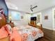 Guest bedroom with hardwood floors, ceiling fan and ensuite bathroom at 13506 Messina Loop # 105, Bradenton, FL 34211