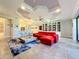 Living area features a red sectional, built-in shelving, and a fireplace at 13506 Messina Loop # 105, Bradenton, FL 34211