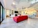 Bright living room features a red sofa, fireplace, and views to the kitchen at 13506 Messina Loop # 105, Bradenton, FL 34211