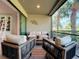 Screened lanai with patio furniture and view of lush landscape at 13506 Messina Loop # 105, Bradenton, FL 34211