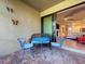 Small patio with blue metal table and chairs, perfect for outdoor dining at 13506 Messina Loop # 105, Bradenton, FL 34211