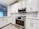 Modern kitchen with stainless steel appliances and white cabinetry at 13506 Messina Loop # 105, Bradenton, FL 34211