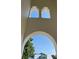 Arched entrance highlighting unique architectural details and design elements, providing a glimpse of the sky at 320 W Park Ave, Tampa, FL 33602