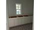 Bathroom with white cabinets and patterned floor tiles at 320 W Park Ave, Tampa, FL 33602