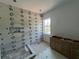 Bathroom with white tiled walls, herringbone floor, and a wood vanity at 320 W Park Ave, Tampa, FL 33602