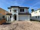Mediterranean-style home featuring a stucco exterior, arched entryway, and a two-car garage at 320 W Park Ave, Tampa, FL 33602