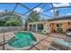 Relaxing screened pool with paver deck and lounge chairs at 7127 Otter Creek Dr, New Port Richey, FL 34655