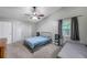 Serene bedroom featuring a ceiling fan and French doors leading to the outdoors at 7127 Otter Creek Dr, New Port Richey, FL 34655