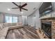 Living room with sectional sofa, fireplace, and wood floors at 7127 Otter Creek Dr, New Port Richey, FL 34655