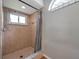 Clean bathroom with shower, window, and gray shower curtain at 7127 Otter Creek Dr, New Port Richey, FL 34655