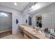 Clean bathroom with a large vanity, mirror, and a walk-in closet at 7127 Otter Creek Dr, New Port Richey, FL 34655