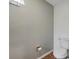 Small half bathroom with toilet and a wall mounted toilet paper holder at 7127 Otter Creek Dr, New Port Richey, FL 34655