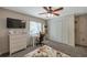 Spacious bedroom with a desk setup, built-in closet, and carpeted floors at 7127 Otter Creek Dr, New Port Richey, FL 34655