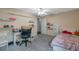 Bright bedroom with a bed, desk, and built-in shelves at 7127 Otter Creek Dr, New Port Richey, FL 34655