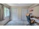 Well-lit bedroom with ample closet space and a workspace at 7127 Otter Creek Dr, New Port Richey, FL 34655