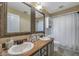 Clean bathroom with double vanity, large mirror, and shower/tub combo at 7127 Otter Creek Dr, New Port Richey, FL 34655