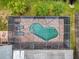 Top-down view of a kidney-shaped pool with a screened enclosure at 7127 Otter Creek Dr, New Port Richey, FL 34655