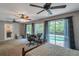 Spacious bedroom with pool view, ceiling fan, and ample natural light at 7127 Otter Creek Dr, New Port Richey, FL 34655