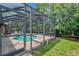 Inviting screened pool area with patio and lush landscaping at 7127 Otter Creek Dr, New Port Richey, FL 34655