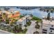 Aerial view showcasing condo complex near the water with parking and landscaping at 10301 Gulf Blvd # 201, Treasure Island, FL 33706