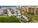 Aerial view of condo complex near beach, showcasing pool and water access at 10301 Gulf Blvd # 201, Treasure Island, FL 33706