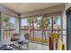 Screened balcony overlooking the street and palm trees at 10301 Gulf Blvd # 201, Treasure Island, FL 33706