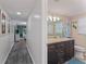 Bright bathroom with granite countertop, updated vanity, and tiled floors at 10301 Gulf Blvd # 201, Treasure Island, FL 33706