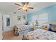 Guest bedroom with twin beds, light blue walls, and ceiling fan at 10301 Gulf Blvd # 201, Treasure Island, FL 33706