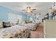 Guest bedroom with two twin beds, coastal bedding, and ceiling fan at 10301 Gulf Blvd # 201, Treasure Island, FL 33706