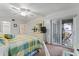 Main bedroom with king bed, private balcony access, and ceiling fan at 10301 Gulf Blvd # 201, Treasure Island, FL 33706