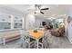 Bright dining area with a wooden table and white chairs, adjacent to the living room at 10301 Gulf Blvd # 201, Treasure Island, FL 33706